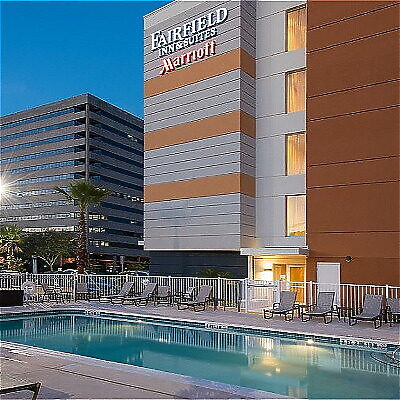 Hotel exterior with swimming pool and lounge chairs