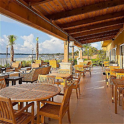 Outdoor seating area with wooden furniture and waterfront view